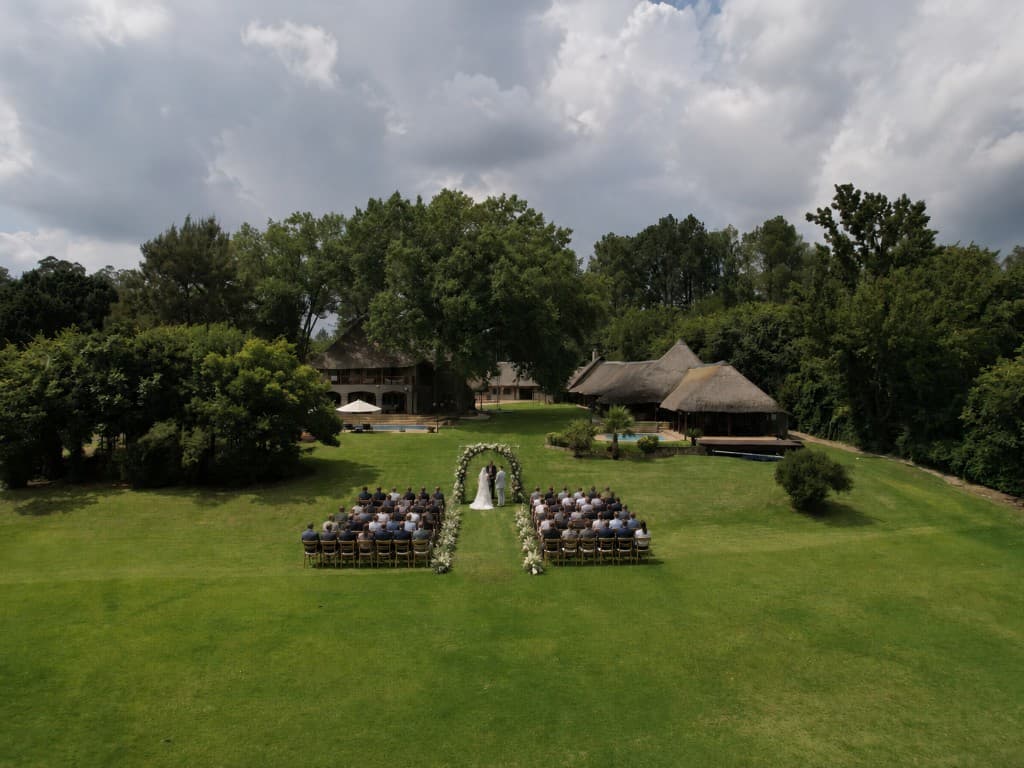 Aerial view of a wedding ceremony on the lawns at Maxwell Stay